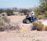 Four wheeler traveling through the desert